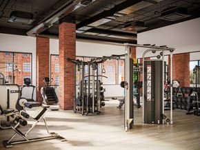 1014 Spurce St apartment for rent - A gym with a variety of equipment including weights and a squat rack.