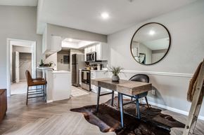 Austin apartment for rent - A modern kitchen with a dining table and chairs.