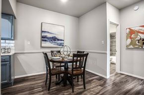 Austin apartment for rent - A dining room with a table set for two and a painting on the wall.