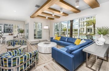 Kissimmee apartment for rent - A modern living room with a blue sofa and a wooden ceiling.
