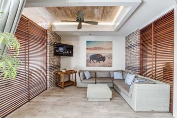 Houston apartment for rent - A living room with a sofa, a table, and a painting of a bison on the wall.