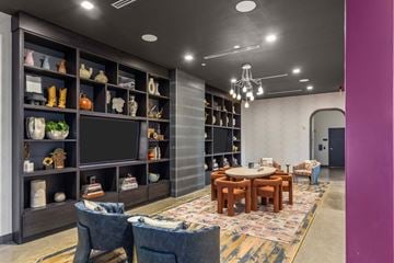 Nashville apartment for rent - A living room with a television, a table, and a rug.