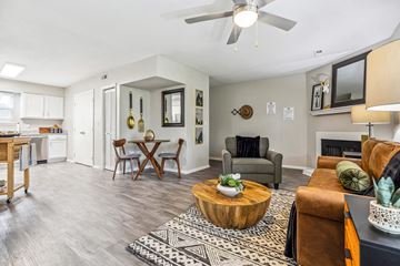 Raleigh apartment for rent - A living room with a brown leather couch and a coffee table.