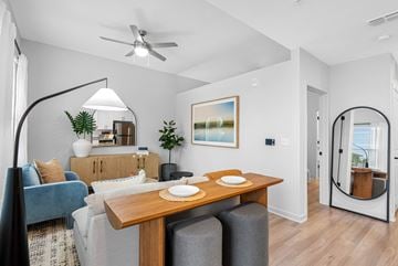 St. Petersburg apartment for rent - A modern living room with a blue couch, a wooden table, and a painting on the wall.