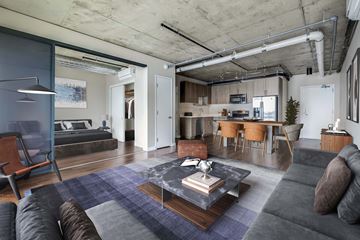 Seattle apartment for rent - A modern living room with a grey couch and a coffee table.