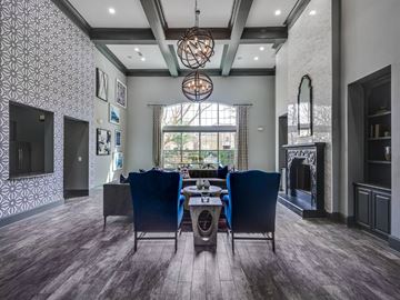 Plano apartment for rent - A modern living room with a dining table and chairs.