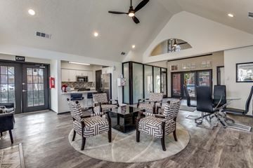 Mckinney apartment for rent - A modern living room with a glass table and striped chairs.