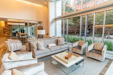 Houston apartment for rent - A living room with a large couch and a coffee table.