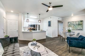 Lewisville apartment for rent - A modern living room with a grey sofa and a white coffee table.