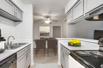 Houston apartment for rent - A kitchen with a table and chairs in the middle.