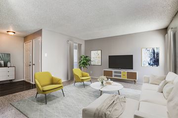 Garland apartment for rent - A living room with a yellow chair and a white couch.