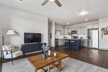 Littleton apartment for rent - A modern living room with a wooden coffee table and a flat screen TV.