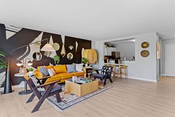 Palatine apartment for rent - A living room with a yellow sofa and a wooden coffee table.