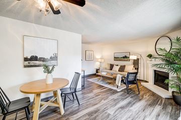 Colorado Springs apartment for rent - A living room with a fireplace and a painting on the wall.