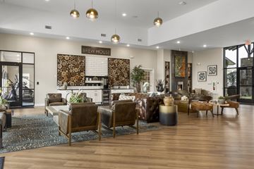 Jenks apartment for rent - A living room with a brown leather couch and a coffee table.