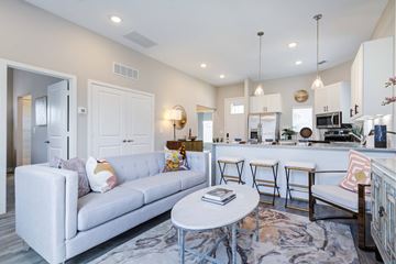 Jenks apartment for rent - A modern living room with a grey sofa and a coffee table.