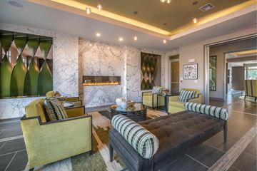 Houston apartment for rent - A living room with a black and yellow sofa and a green chair.