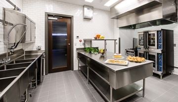 Houston apartment for rent - A kitchen with a stainless steel counter and a tray of food on it.