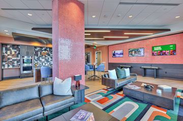 Nashville apartment for rent - A modern living room with a grey sofa and a wooden coffee table.