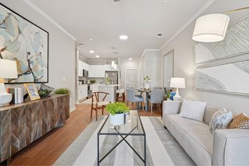 Montgomery apartment for rent - A modern living room with a glass coffee table and a large painting on the wall.