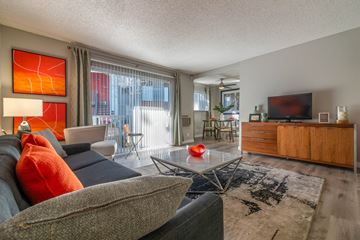 Sunnyvale apartment for rent - A living room with a grey couch and a red pillow.