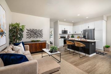Highland apartment for rent - A modern living room with a beige couch and a coffee table.