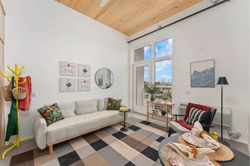 Sacramento apartment for rent - A living room with a white couch and a checkered floor.