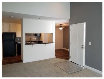 Livermore apartment for rent - A kitchen area with a refrigerator, microwave, and a countertop with a sink.