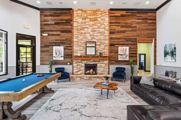 Rincon apartment for rent - A living room with a pool table and a fireplace.