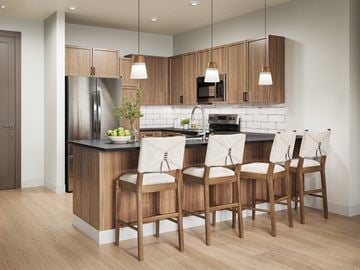 Broomfield apartment for rent - A kitchen with wooden chairs and a white counter.