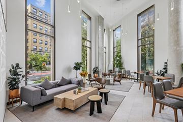 Washington Dc apartment for rent - A living room with a grey couch and wooden coffee table.