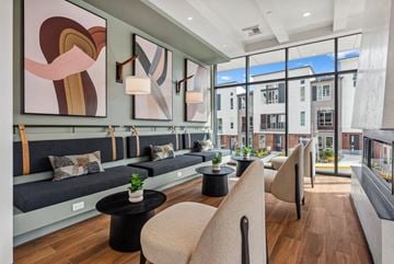 Redmond apartment for rent - A modern living room with a long couch and a large abstract painting above it.