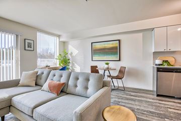 Seattle apartment for rent - A modern living room with a grey sofa and a wooden table.