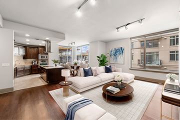 Washington apartment for rent - A modern living room with a white sofa and a coffee table.