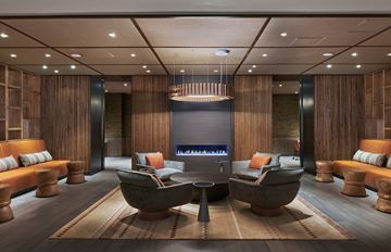 Washington apartment for rent - A modern living room with a large wooden table and sofas.