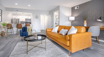 Indianapolis apartment for rent - A modern living room with a yellow sofa and a coffee table.