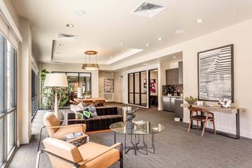 San Jose apartment for rent - A modern living room with a glass table and chairs.