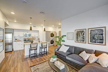 Fort Collins apartment for rent - A modern living room with a grey couch and a coffee table.