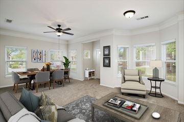 Overland Park apartment for rent - A living room with a grey couch, a coffee table, a dining table with chairs, and a ceiling fan.