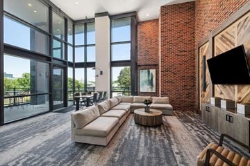 Charleston apartment for rent - A modern living room with a large sectional sofa and a coffee table.