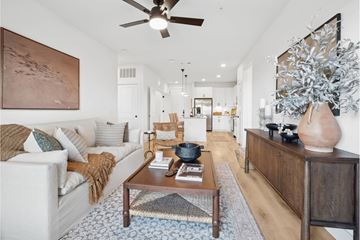 Mckinney apartment for rent - A living room with a white couch and a wooden coffee table.