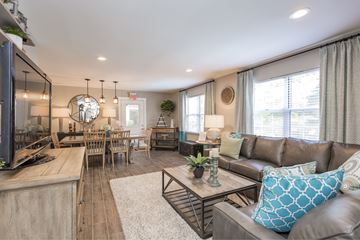 Nashville apartment for rent - A living room with a brown leather couch and a wooden coffee table.