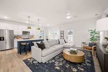 Charlotte apartment for rent - A modern living room with a grey couch and a coffee table.