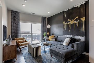 Denver apartment for rent - A living room with a large black and gold painting on the wall.