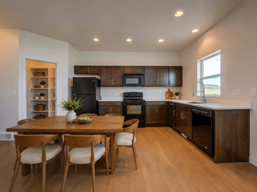 Bluffdale townhouse for rent - A modern kitchen with wooden chairs and a dining table.