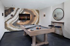 San Diego apartment for rent - A pool table in a room with a marble patterned wallpaper.