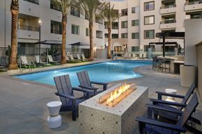 Anaheim apartment for rent - A pool with a fire pit in the middle of it.