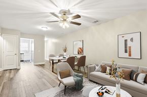 Pooler apartment for rent - A living room with a couch, chairs, and a dining table.