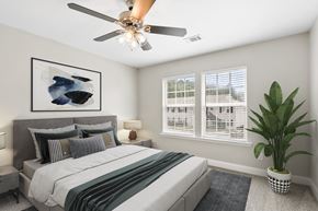 Pooler apartment for rent - A bedroom with a bed, a ceiling fan, and a potted plant.