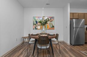 Charlotte apartment for rent - A dining room with a table set for two and a painting on the wall.